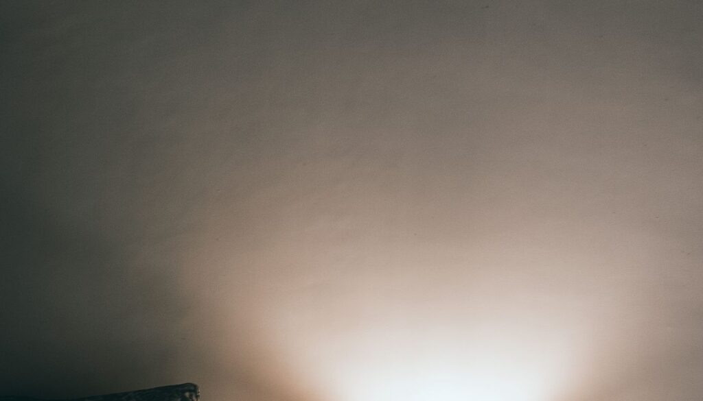 A softly lit bedside lamp in a tidy bedroom, the kind of calm evening setting a wind-down routine asks for