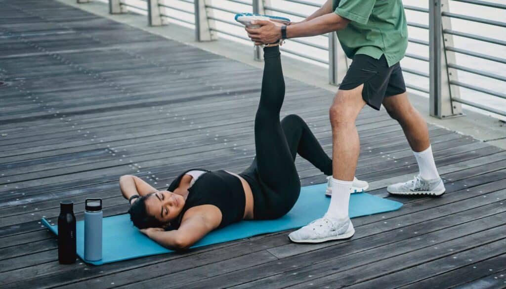 A woman stretching calmly on a yoga mat at home, the kind of steady daily routine Ayurveda uses to keep the doshas balanced